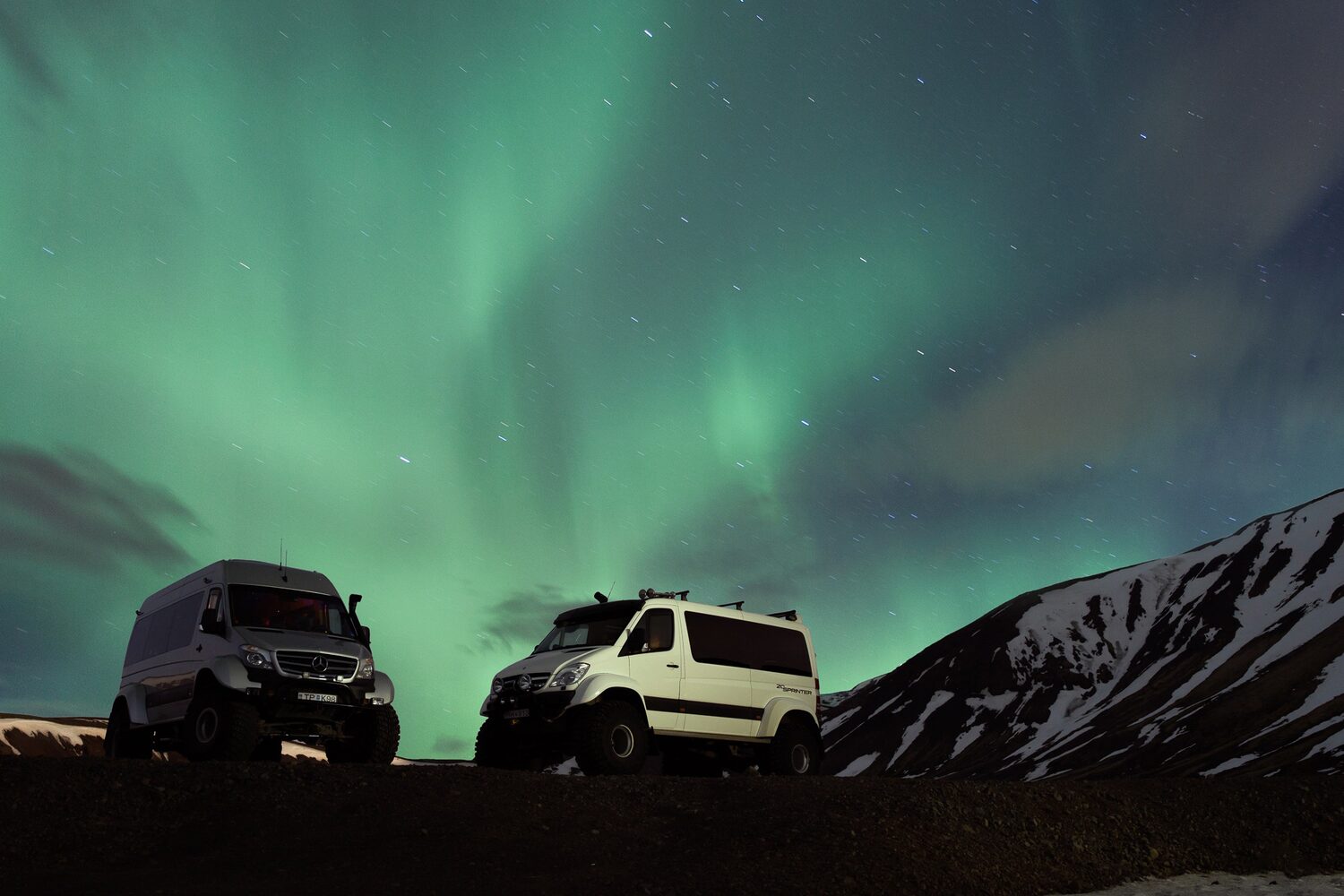 Super jeeps with northern lights above