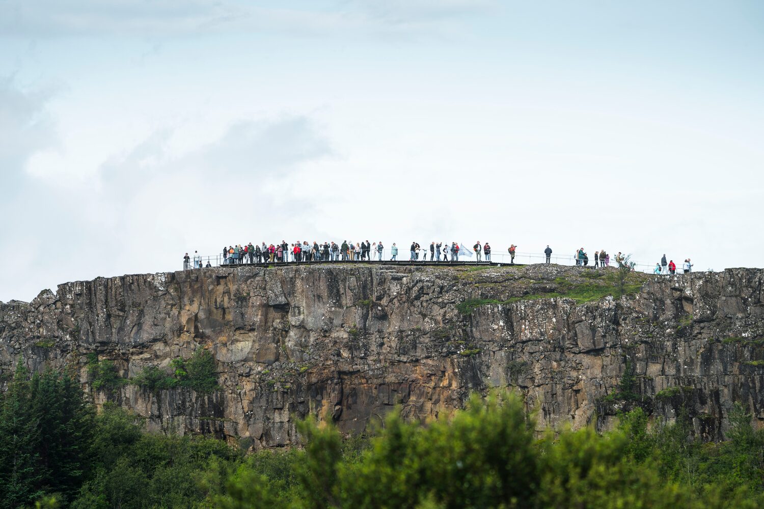 People on tectonic plate in Thingvellir National Park