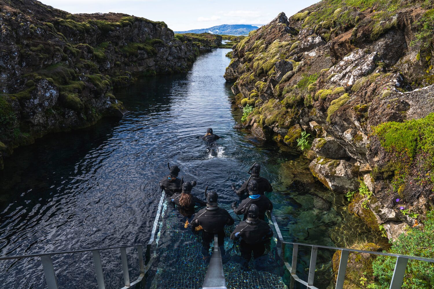 People by shore of Silfra Fissure in Iceland