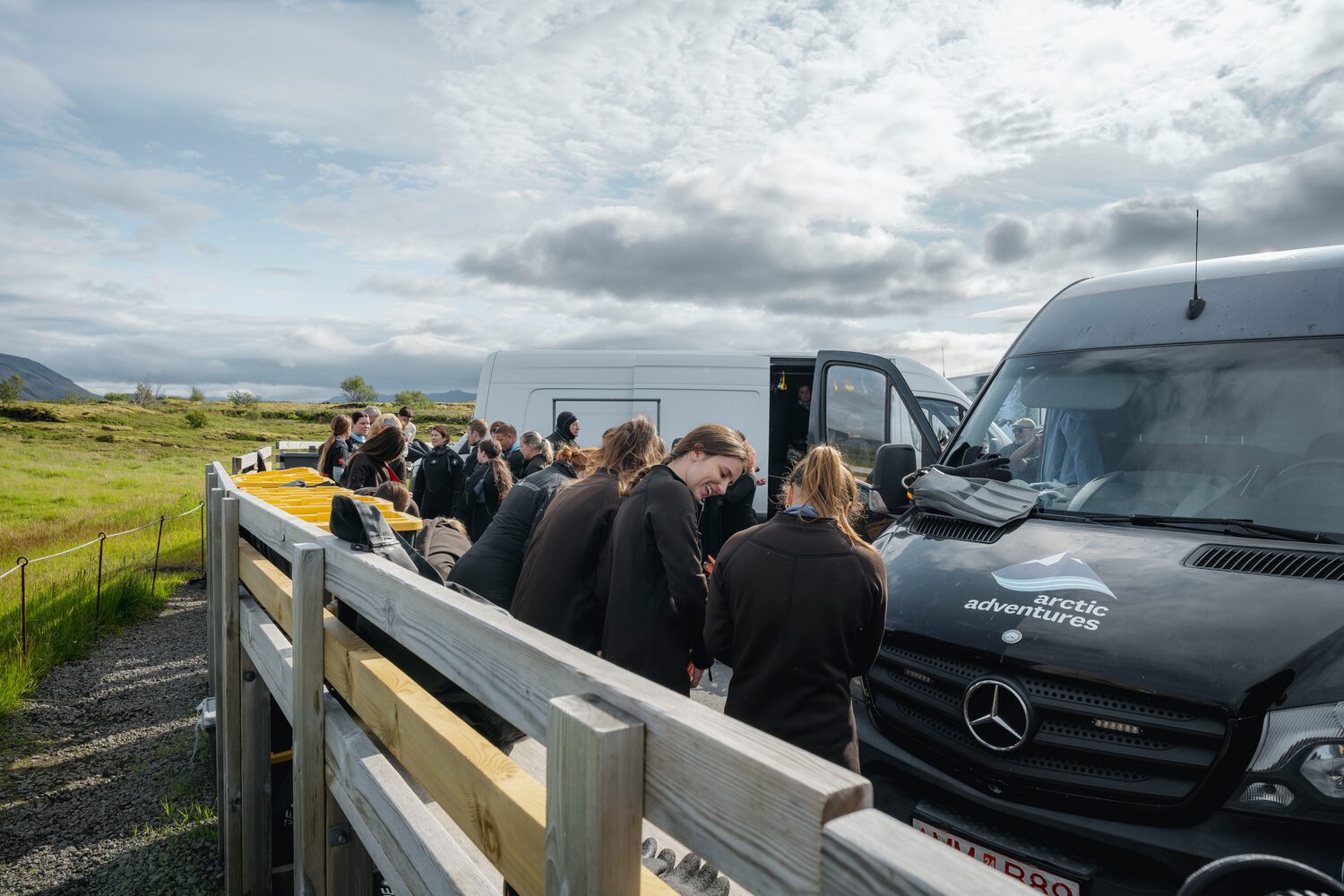 People dressing for snorkeling by busses