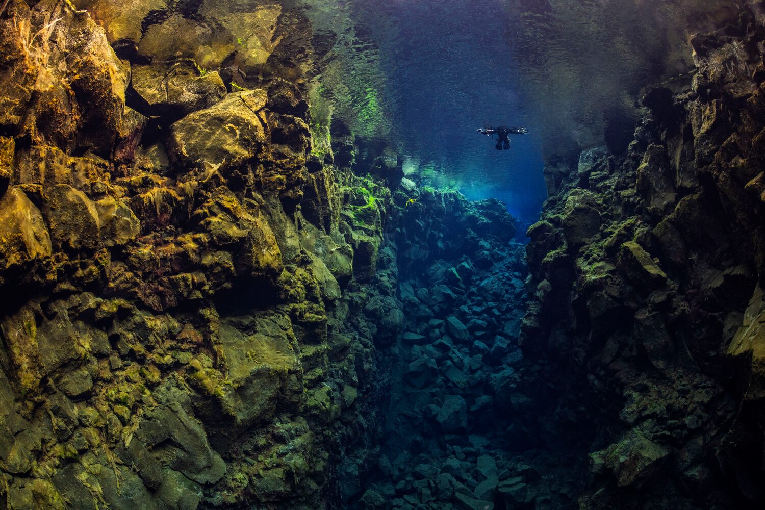 Snorkeler swimming in clear waters of Silfra Fissure