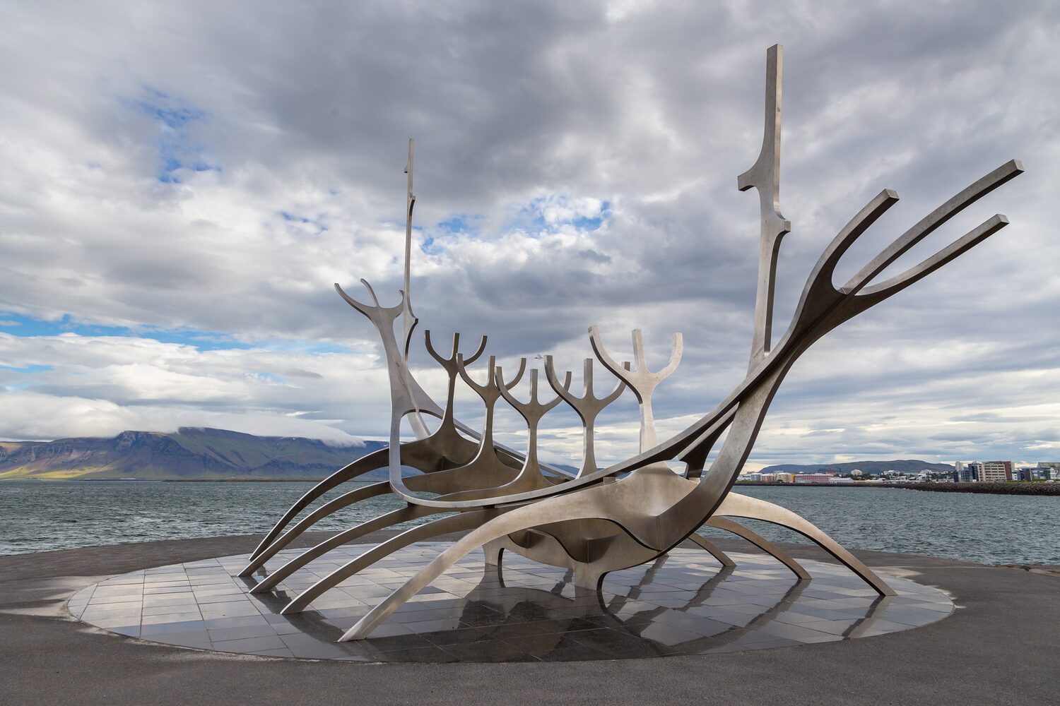 Street view of Solfar, Sun Voyager, located next to the Saebraut road. Steel boat sculpture by the sea.