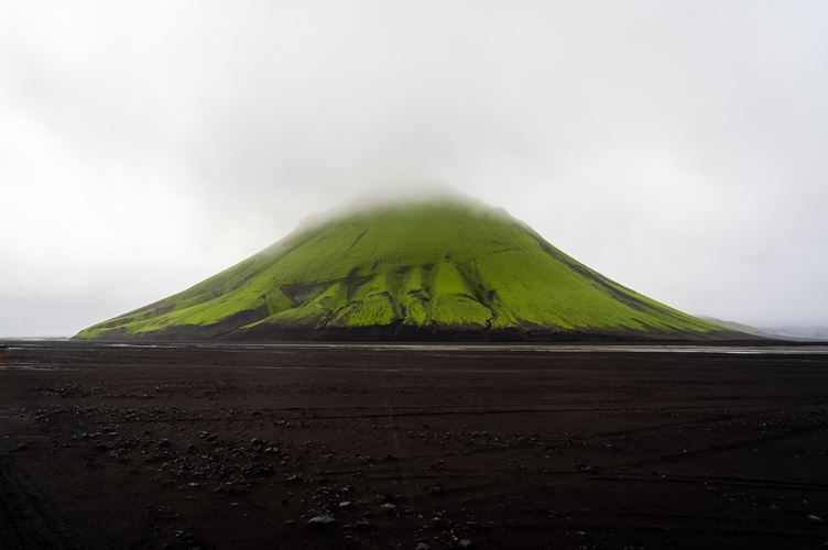 Mt. Mælifell Mælifellssandur Vivid green mountain surrounded by black sand desert