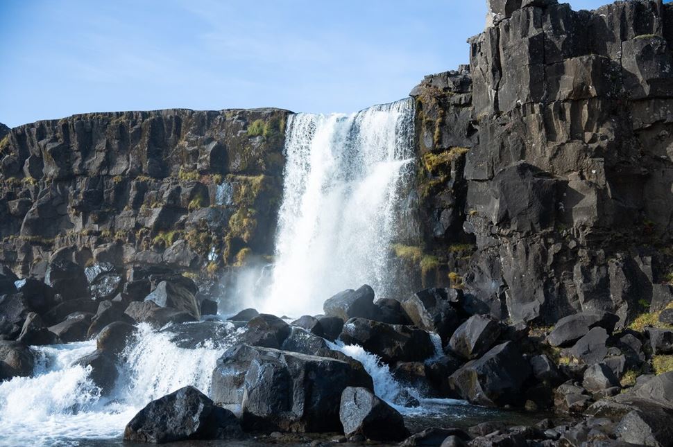 Oxararfoss Waterfall Waterfall flowing over rocky mountain cliff at Thingvellir