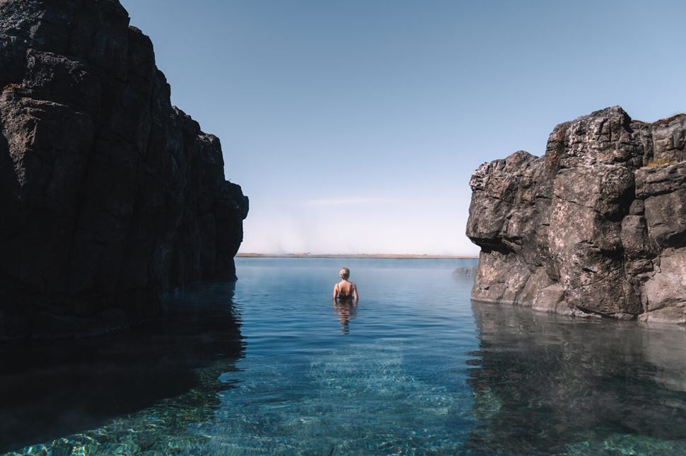 Woman bathing in Sky lagoon