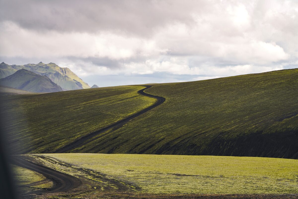 Long trail in green fields of Iceland