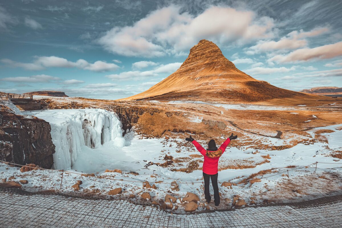 Excited woman near Kirkjufell mountain