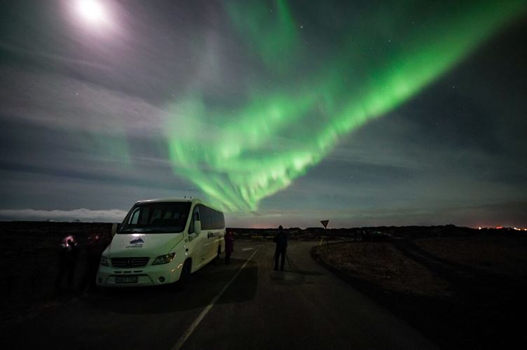 Aurora above minibus at night