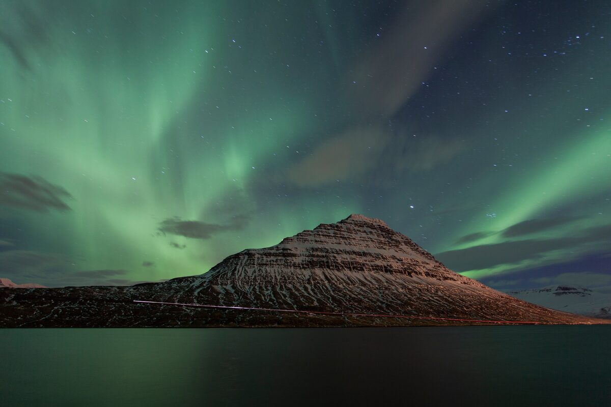 Aurora above snowy mountain in Iceland