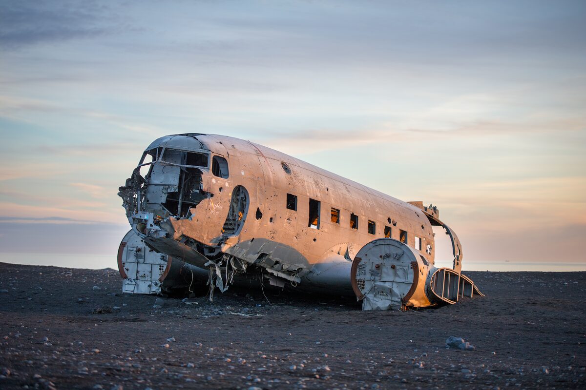Plane remains in black sand beach