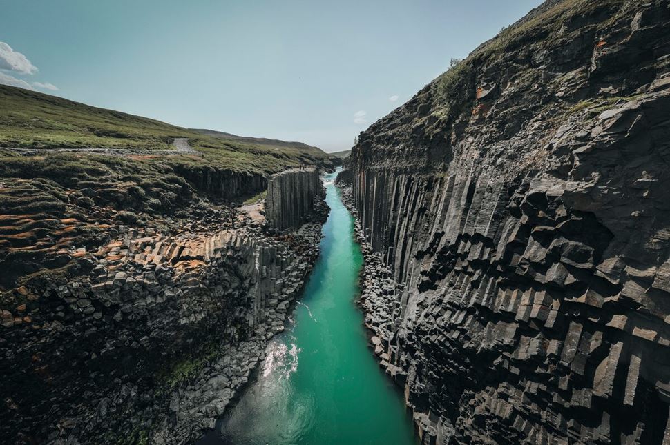 Studagil Canyon  Stacked canyon with beautiful sea green and a blue clear river running through landscape