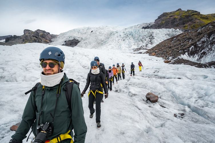 Glacier hiking tour group going back