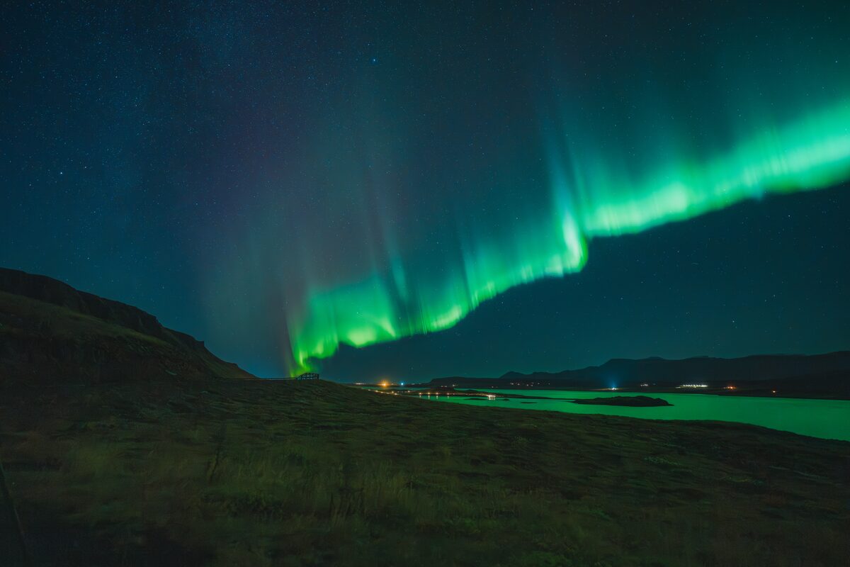 Bright green northern light through the sky.