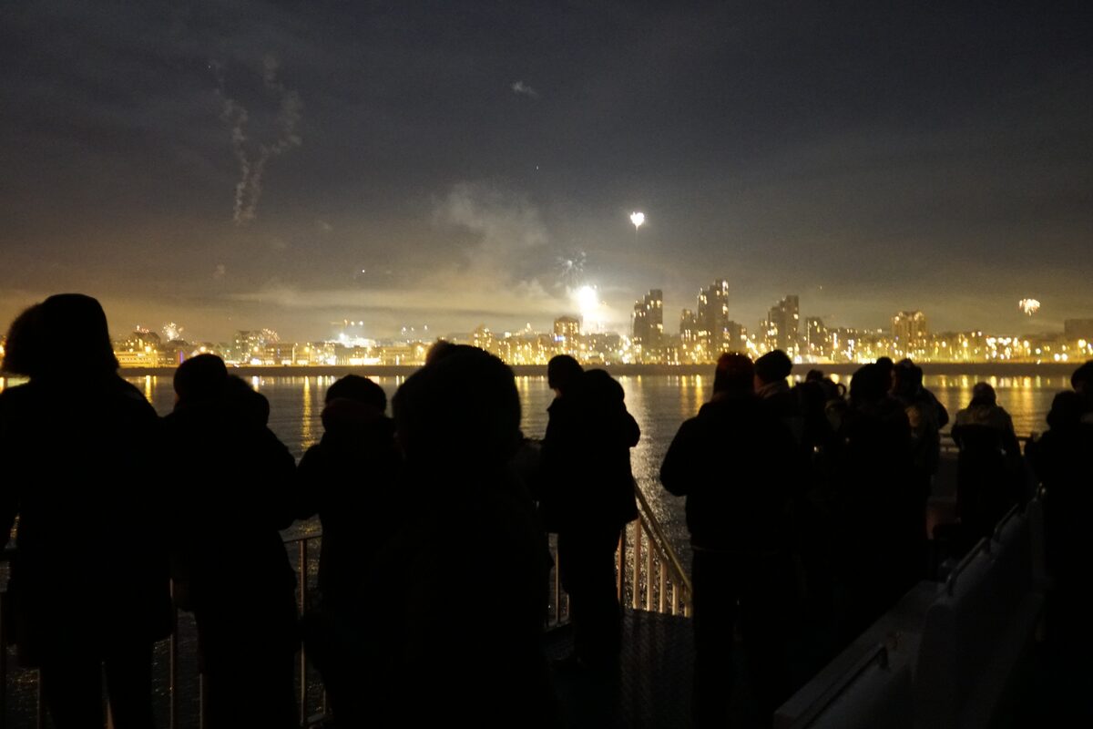 People watching fireworks from boat near Reykjavik