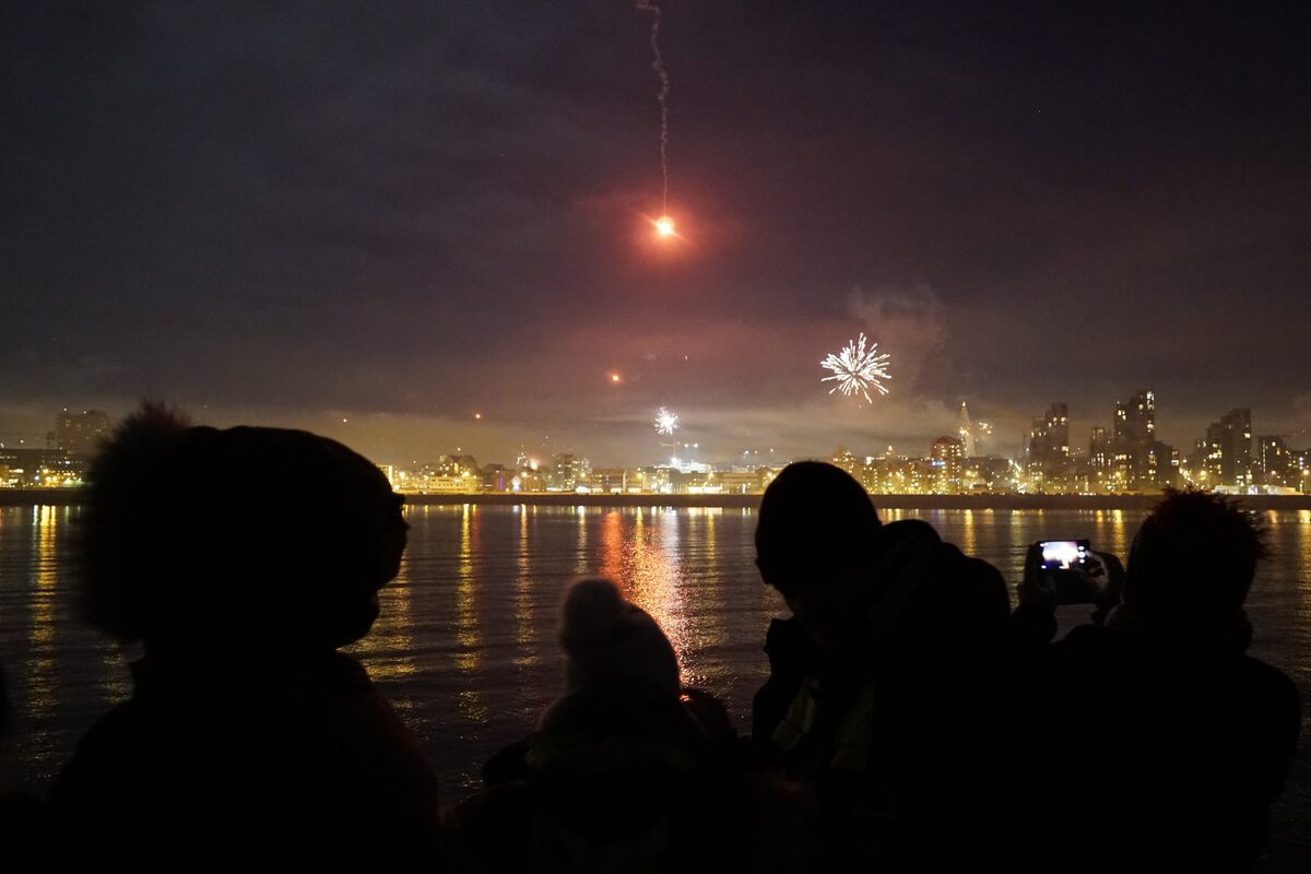 People watching fireworks from boat