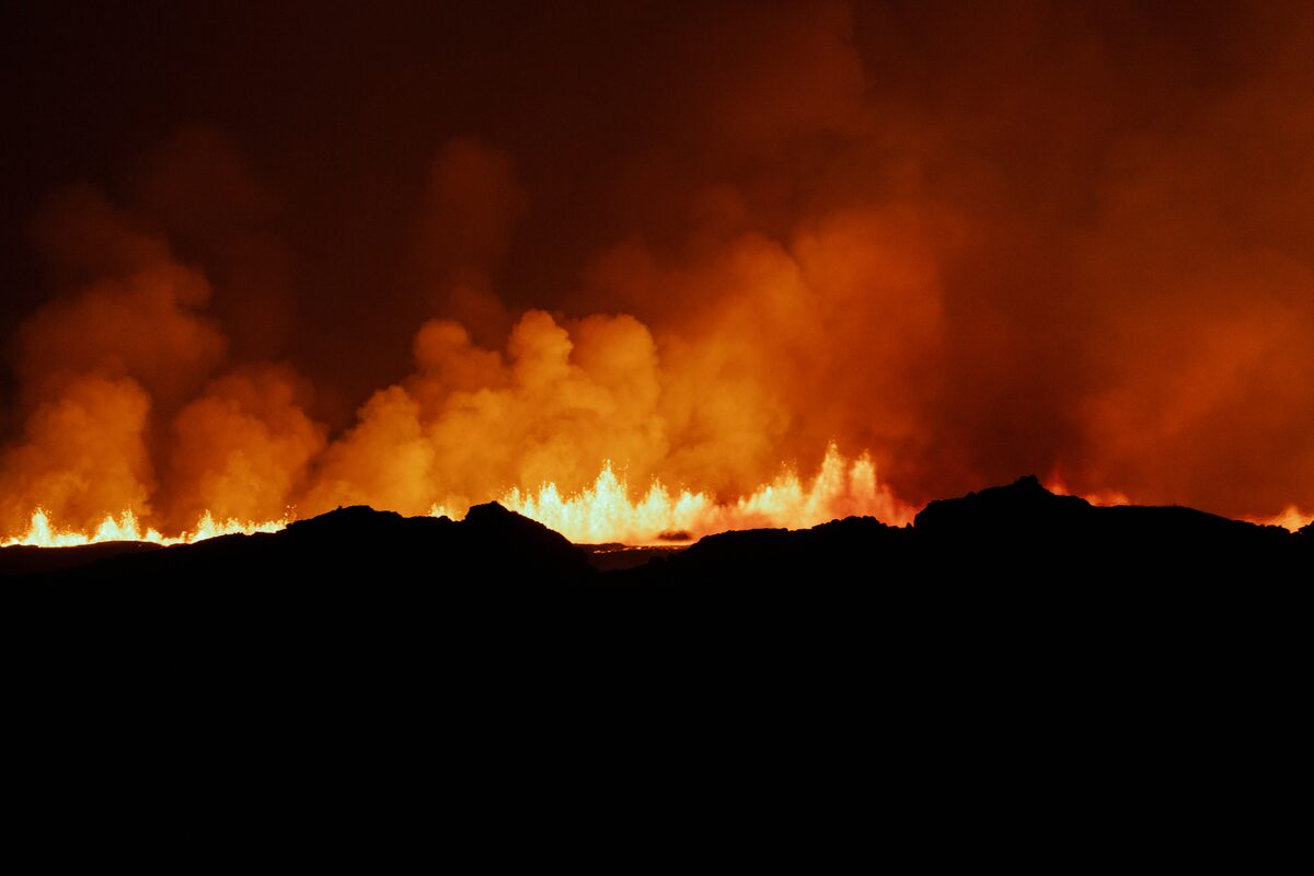Lava erupting from crack at night in Iceland