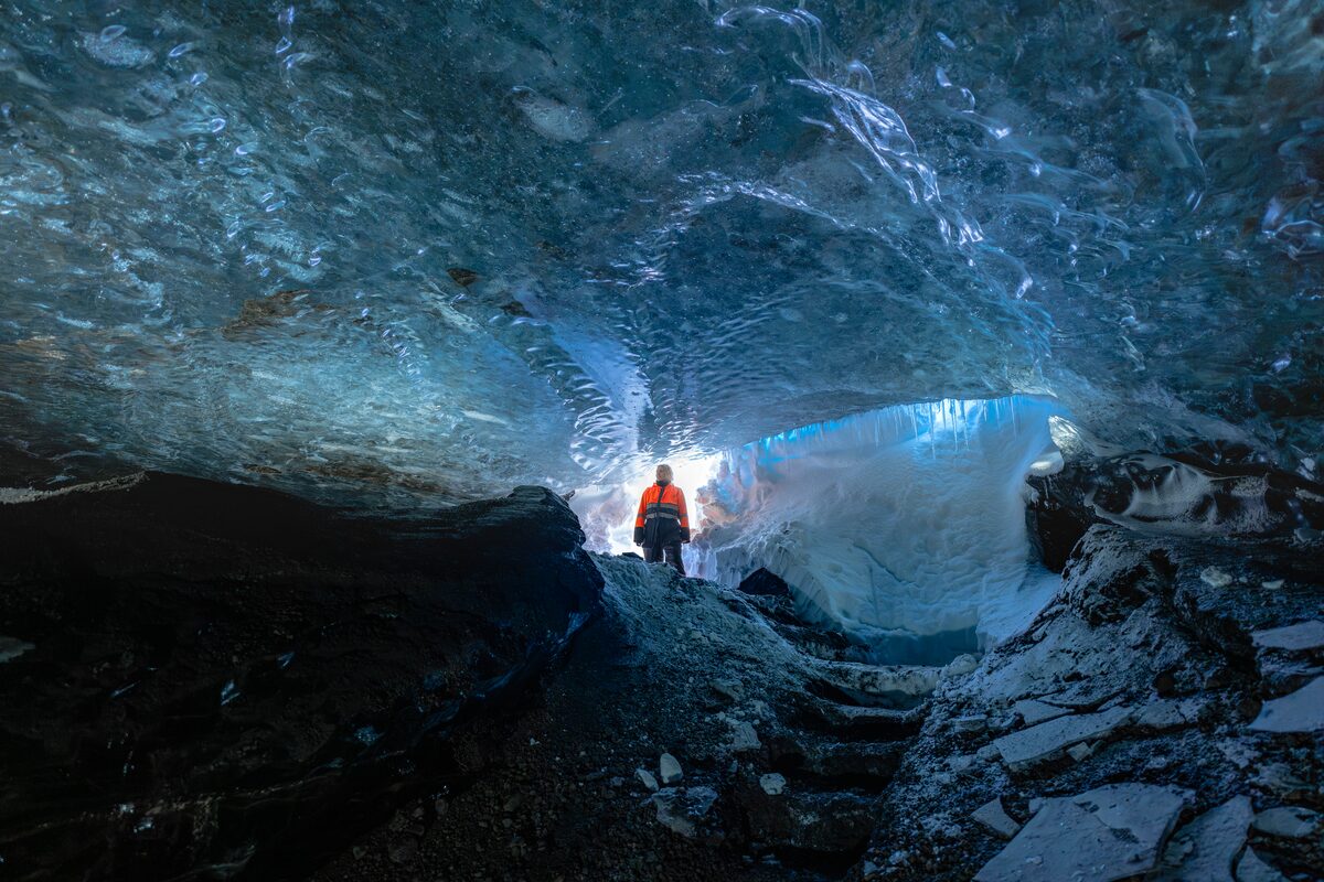 Woman in dark blue ice cave