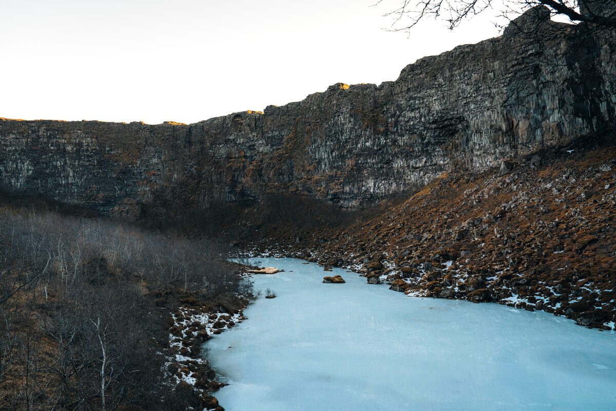 Close up view of Asbyrgi canyon in winter with icy blue stream
