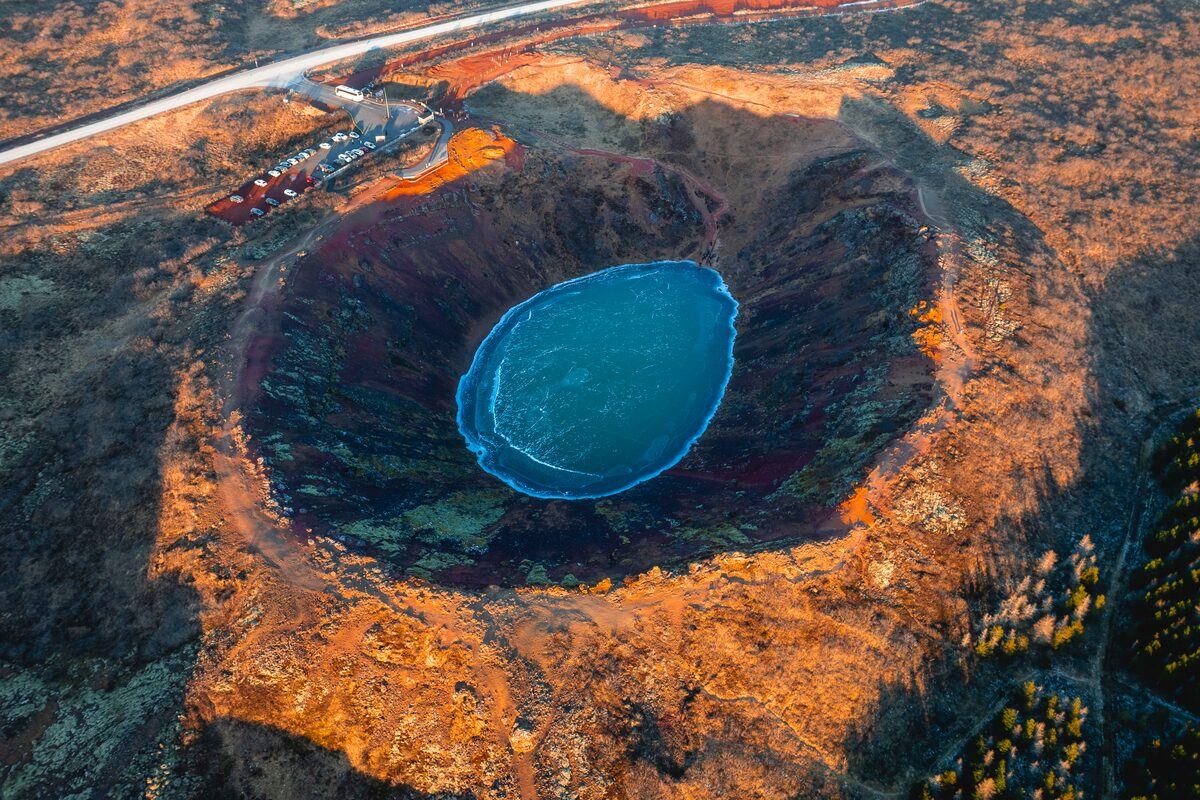 Kerid volcanic crater lake from ariel view with blue water pool during autumn 