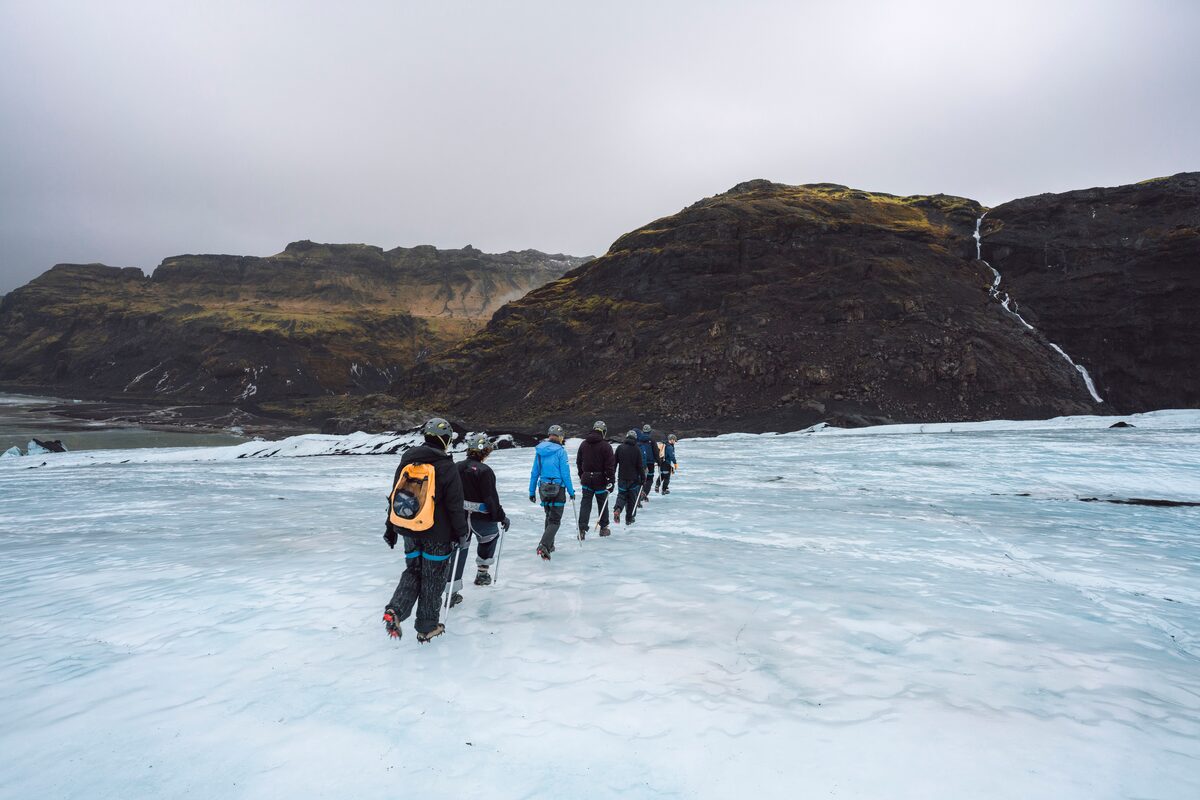 Group walking in a row on glacier