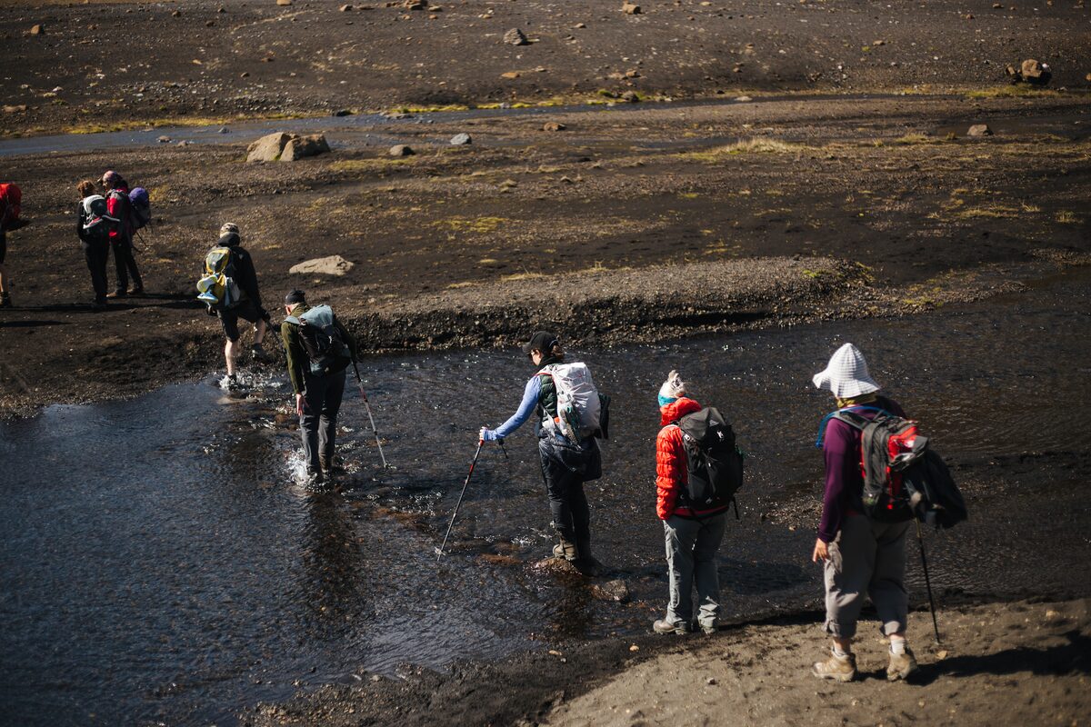 Small group crossing river by foot
