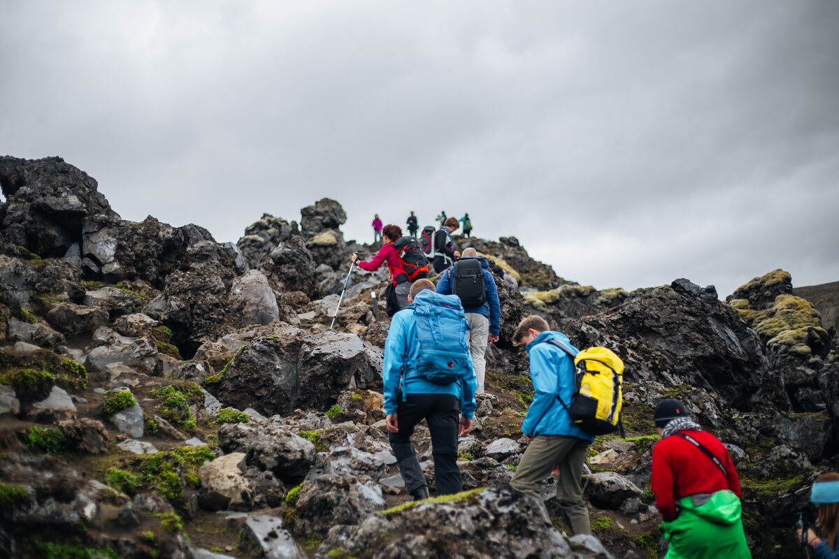 Group of hikers climbing up the mountain