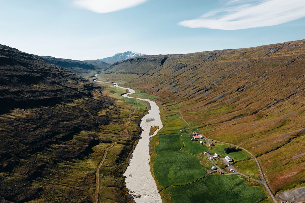 Ariel view of green fields and stream surrounding the Wilderness center 
