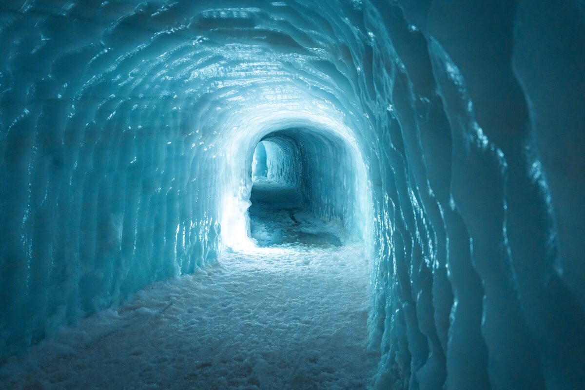 Langjokull glacier tunnel view down whole tunnel with blue ice walls