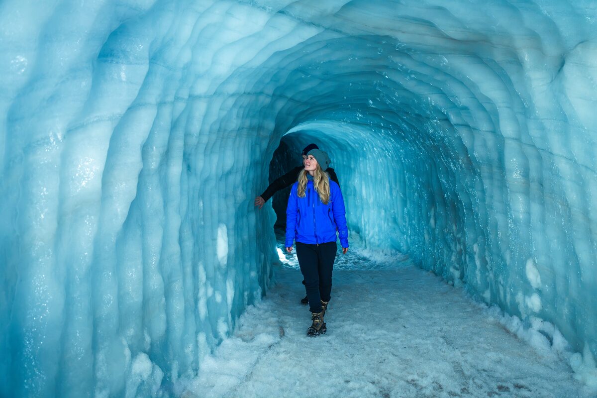 Female tourist walking inside Langjokull ice tunnel 