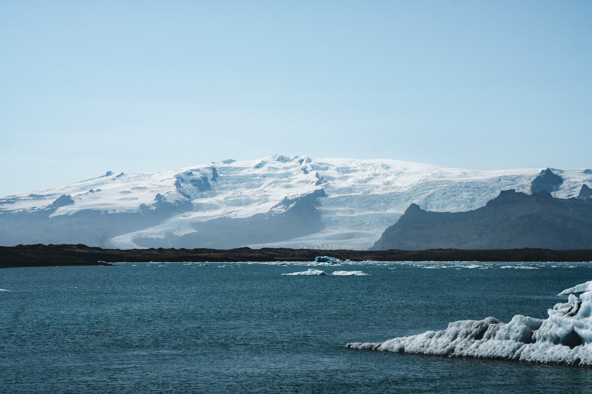 Landscape of arctic glacier lagoon at the skyline a huge snow covered mountain 