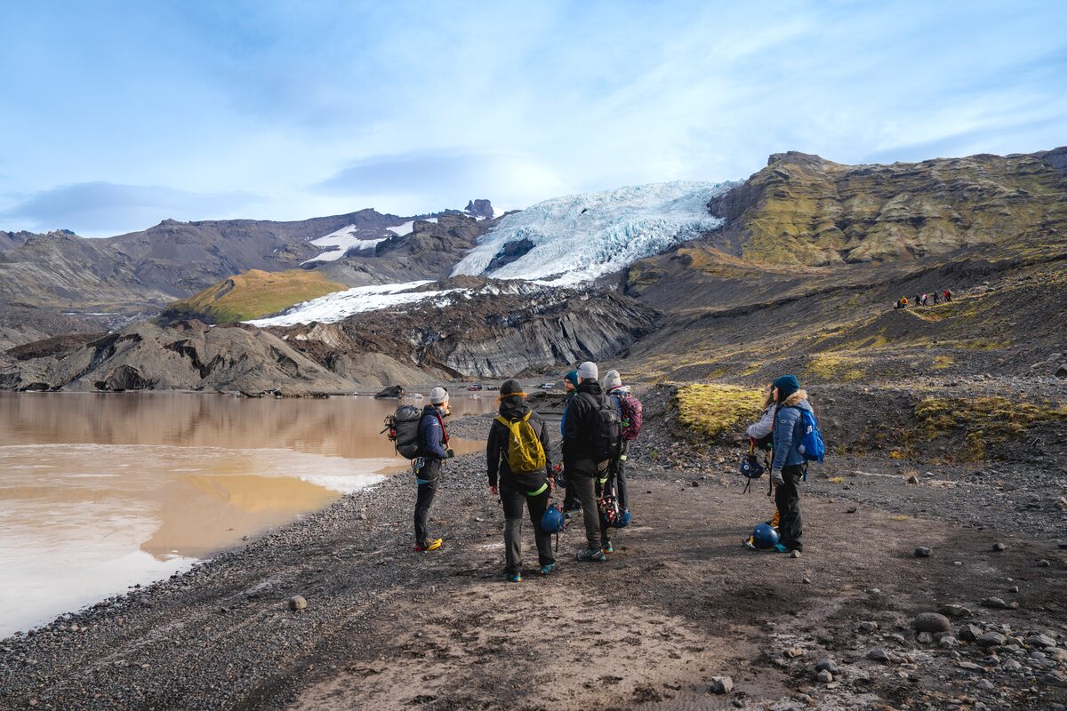 Small tour group looking up towards Falljokull glacier 