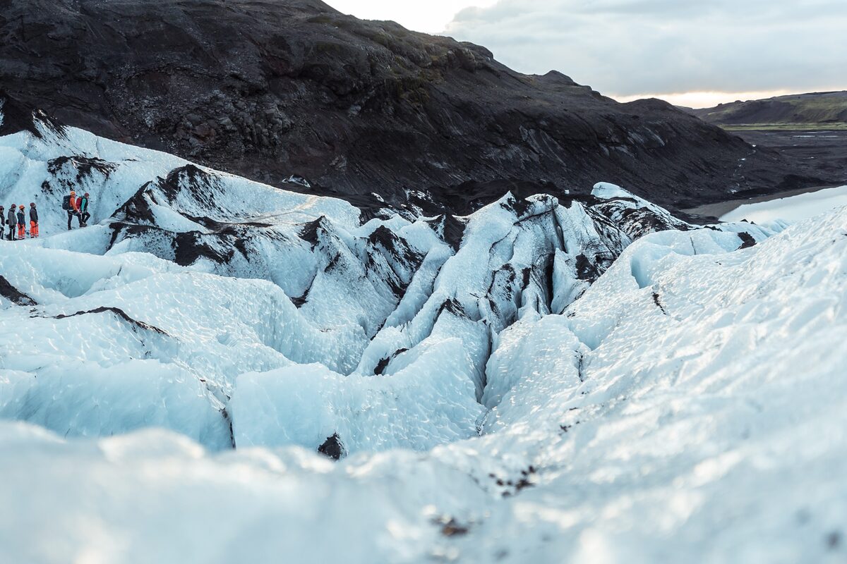 Large ice crevasses on Solheimajokull with black volcanic ash forming patterns