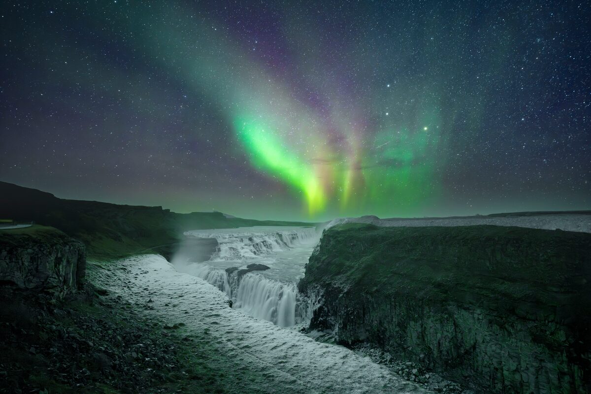 Gullfoss waterfall in the evening with breathtaking northern lights over head