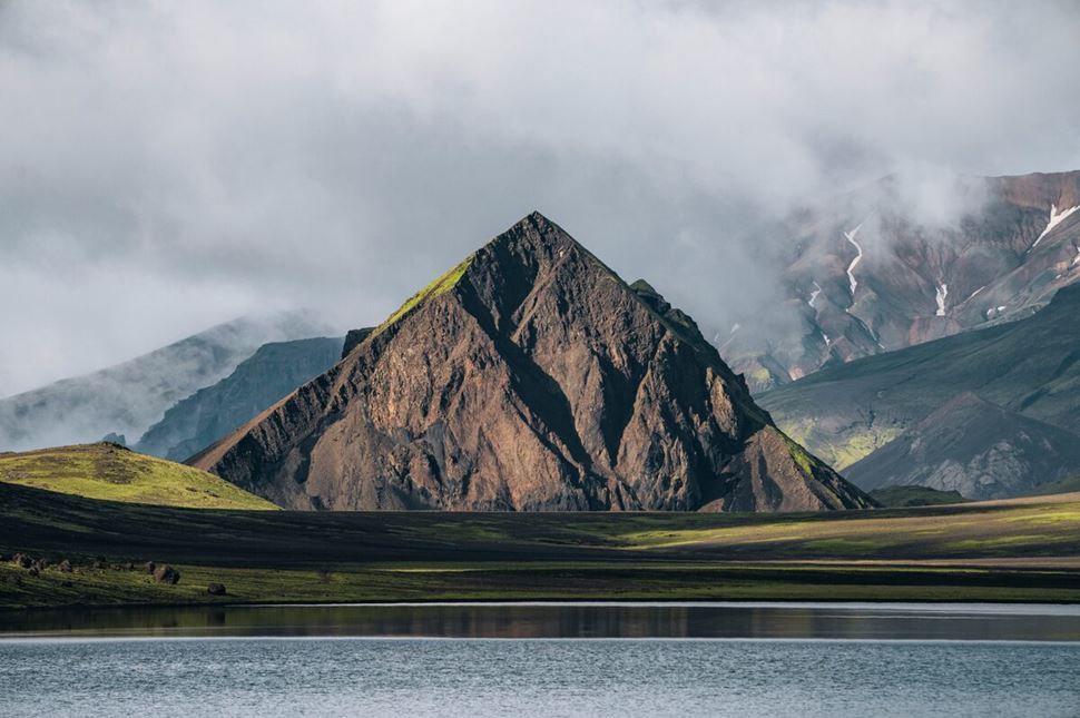 Mountain views from Laugavegur Trek. Triangle shaped mountain across lake in Alftavatn, Iceland