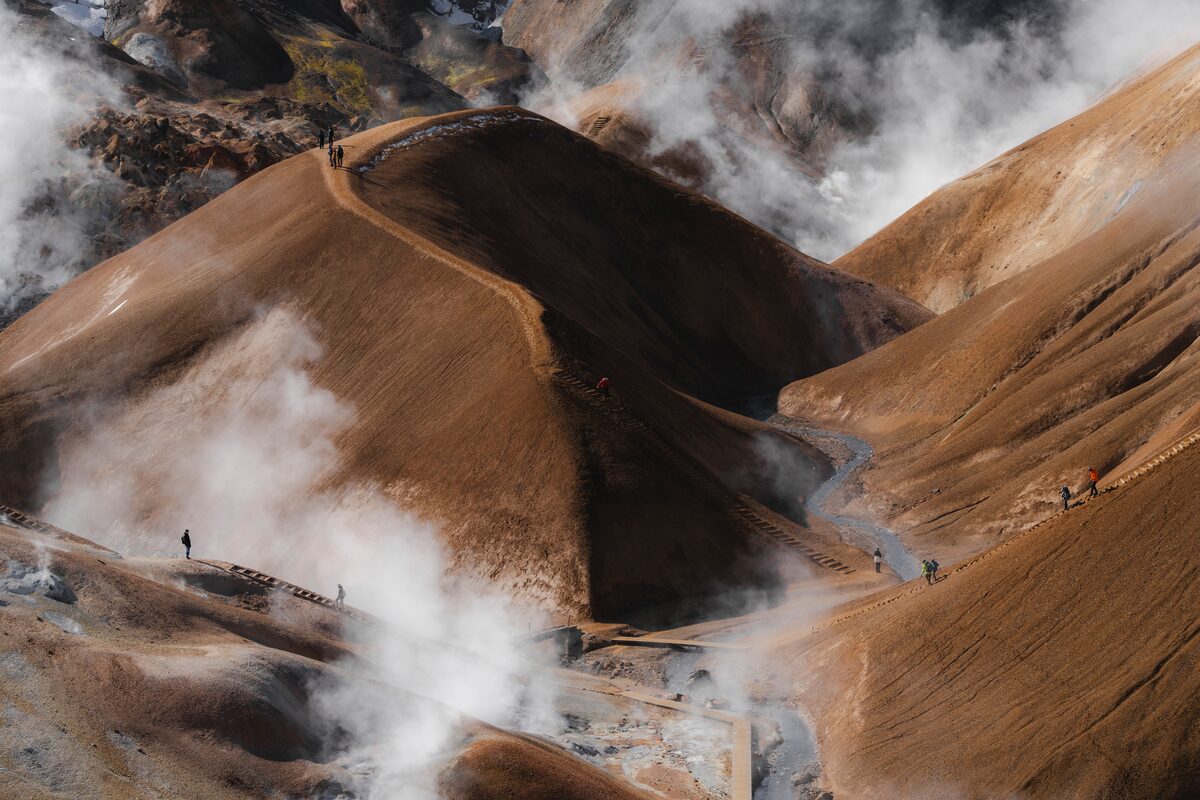 Cloud covered brown Kerlingarfjoll mountain pathways, with tourists walking the trail