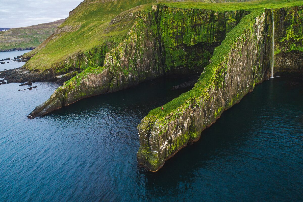 Grass covered Hornstrandir cliff edges leading out to sea 