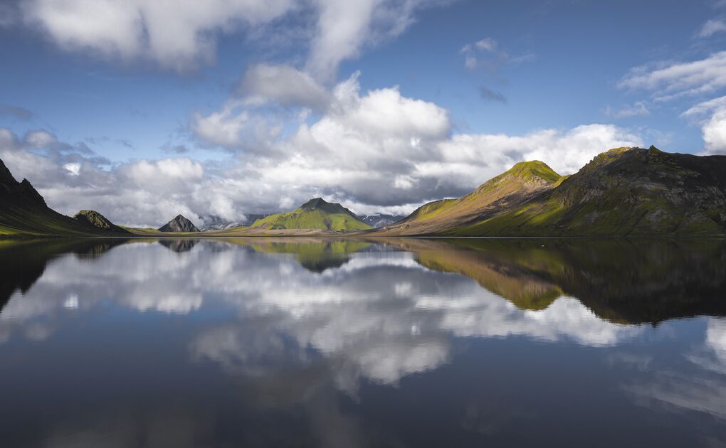 Beautiful view of Alftavatn lake with mountain reflecting into lake on sunny day 