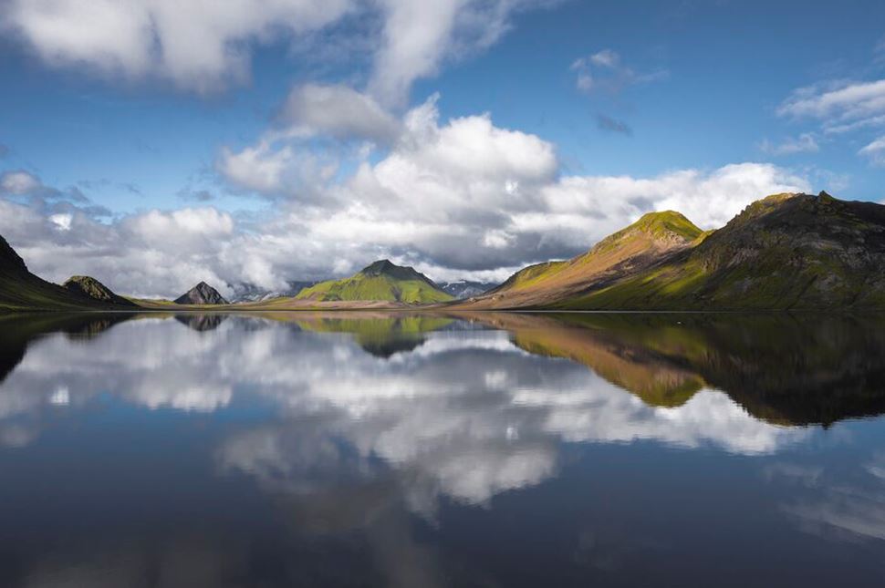 Beautiful view of Alftavatn lake with mountain reflecting into lake on sunny day