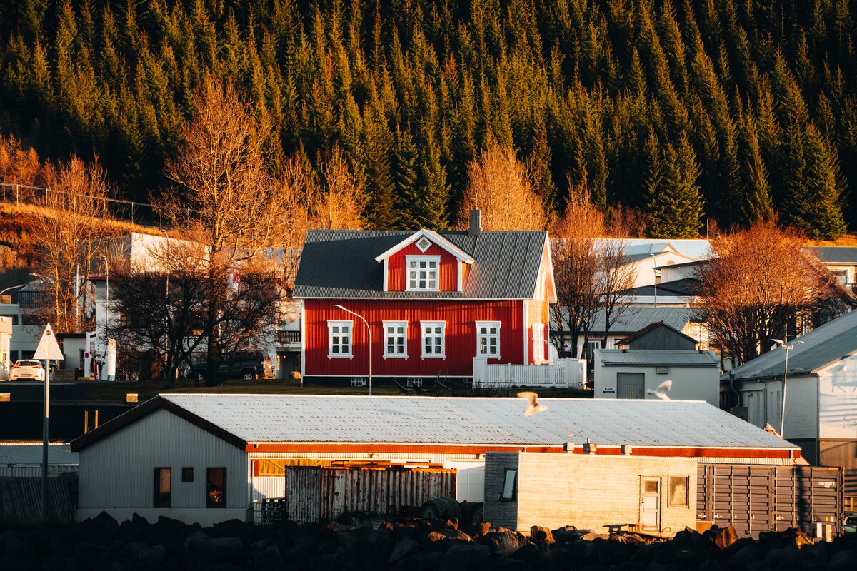 Red houses in small village of Husavik in autumn during sunset