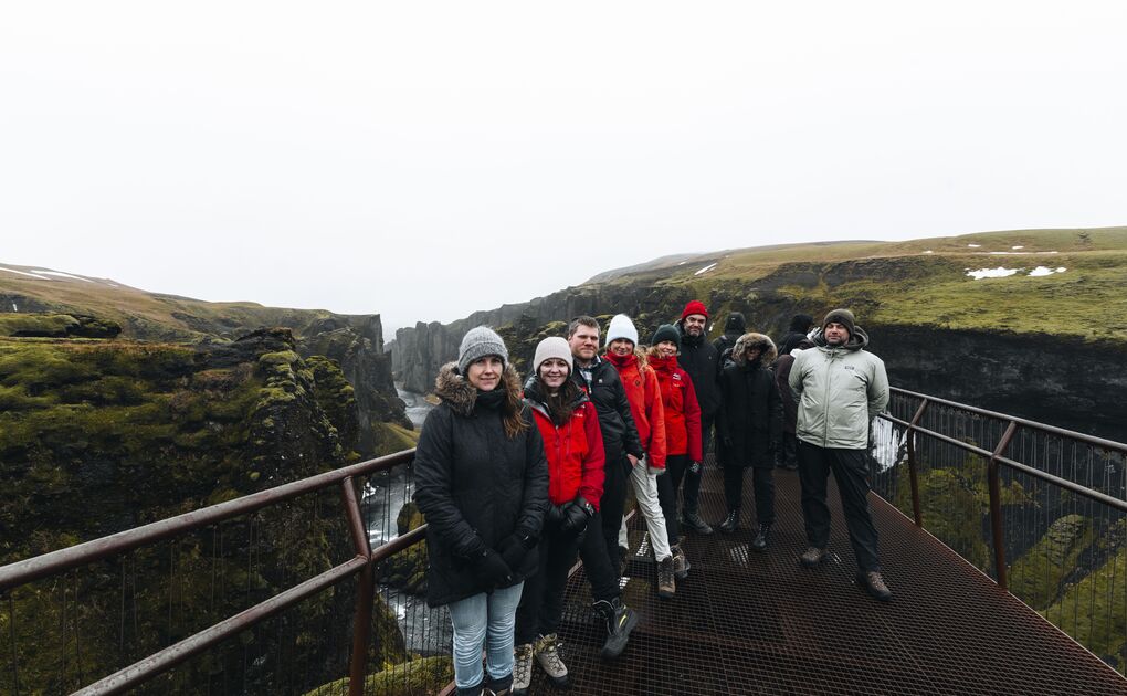 Small group posing for photo at Fjardargljufur Canyon