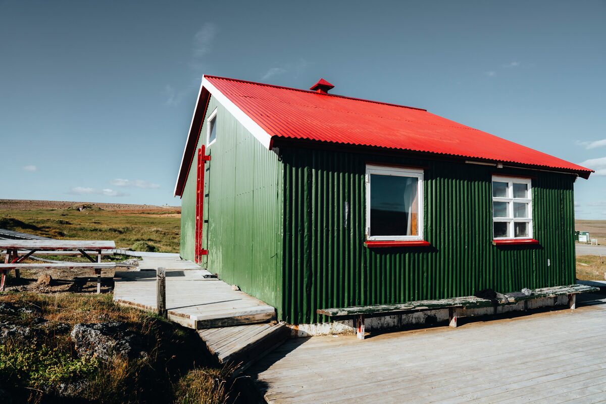 Hveravellir camping site green wooden hut with red roof 