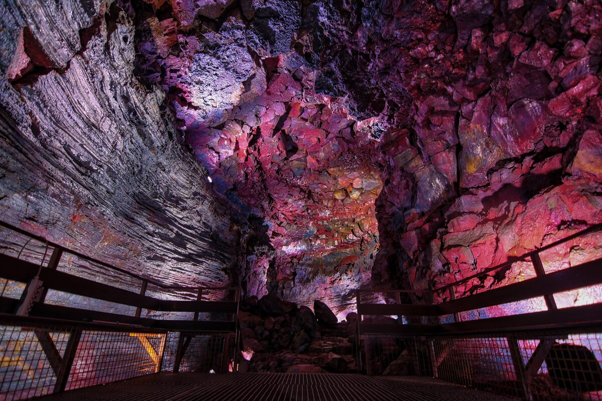 Bright purple lava rock formations inside Raufarhólshellir lava tunnel.