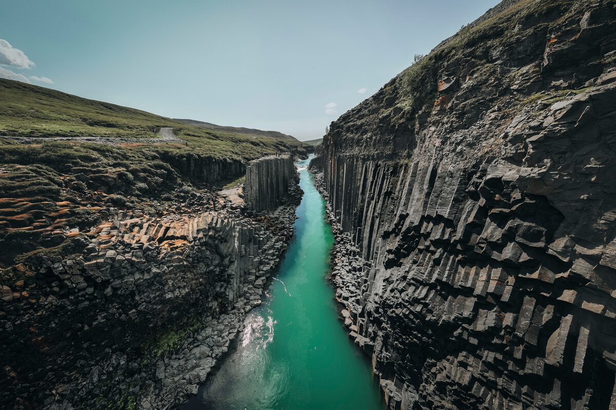 Birds eye view of Studlagil canyon and turquoise river during summer in Iceland.