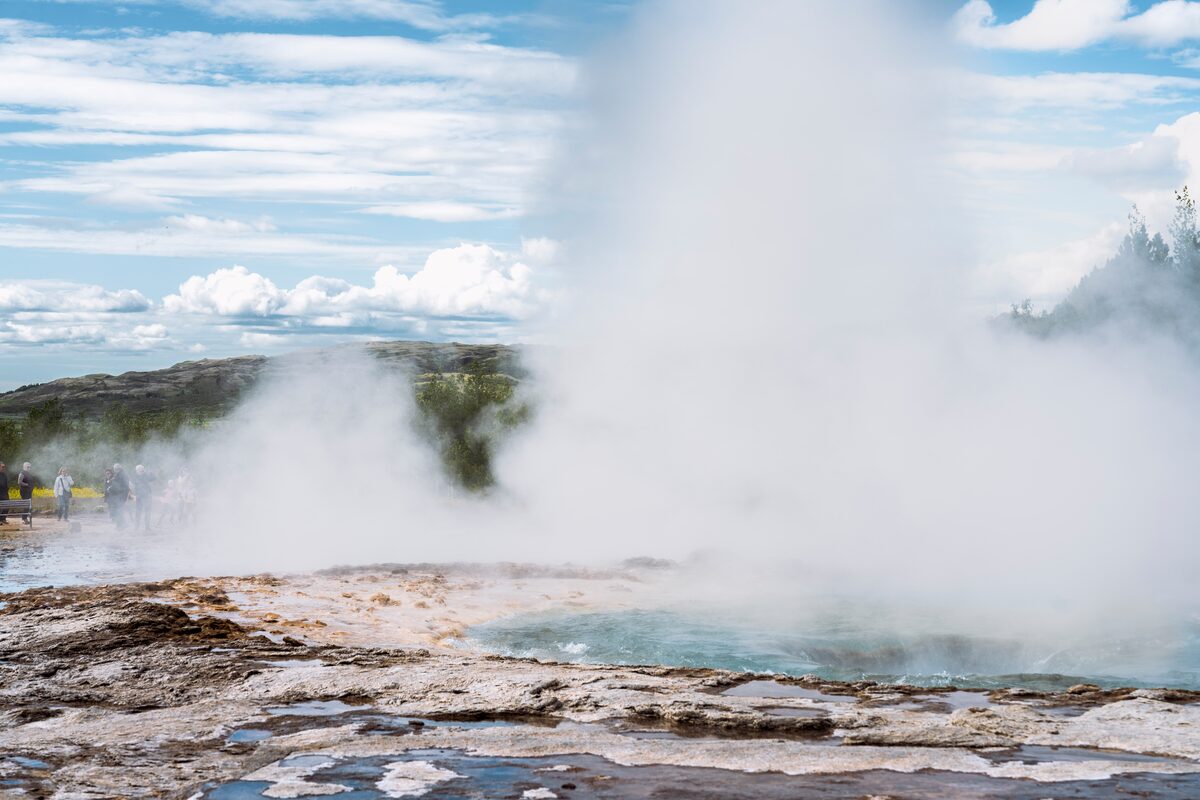 Close up view of a geysir steaming and actively erupting in golden circle Iceland.