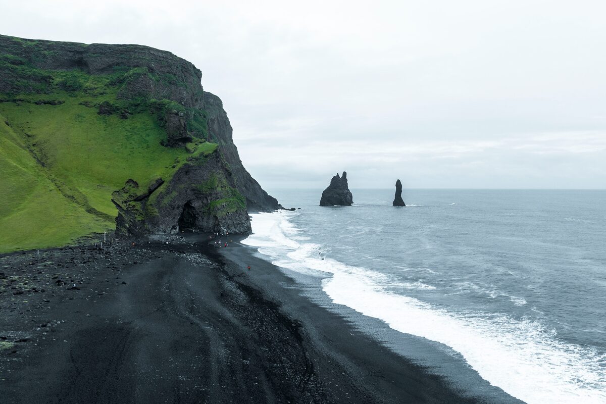 Coastal landscape at Reynisfjara South Coast black sand beach on a cloudy overcast day.