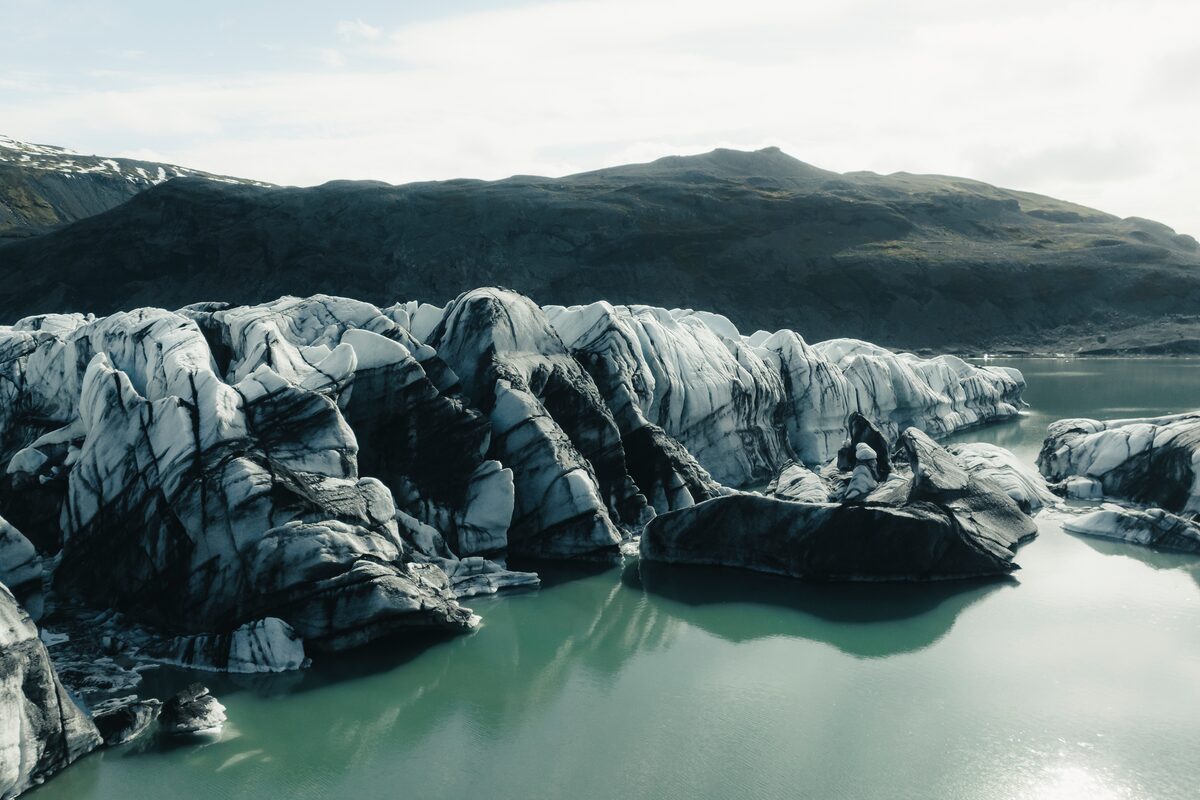 Close up of Solheimajokull glacier lagoon with black ash pattern.