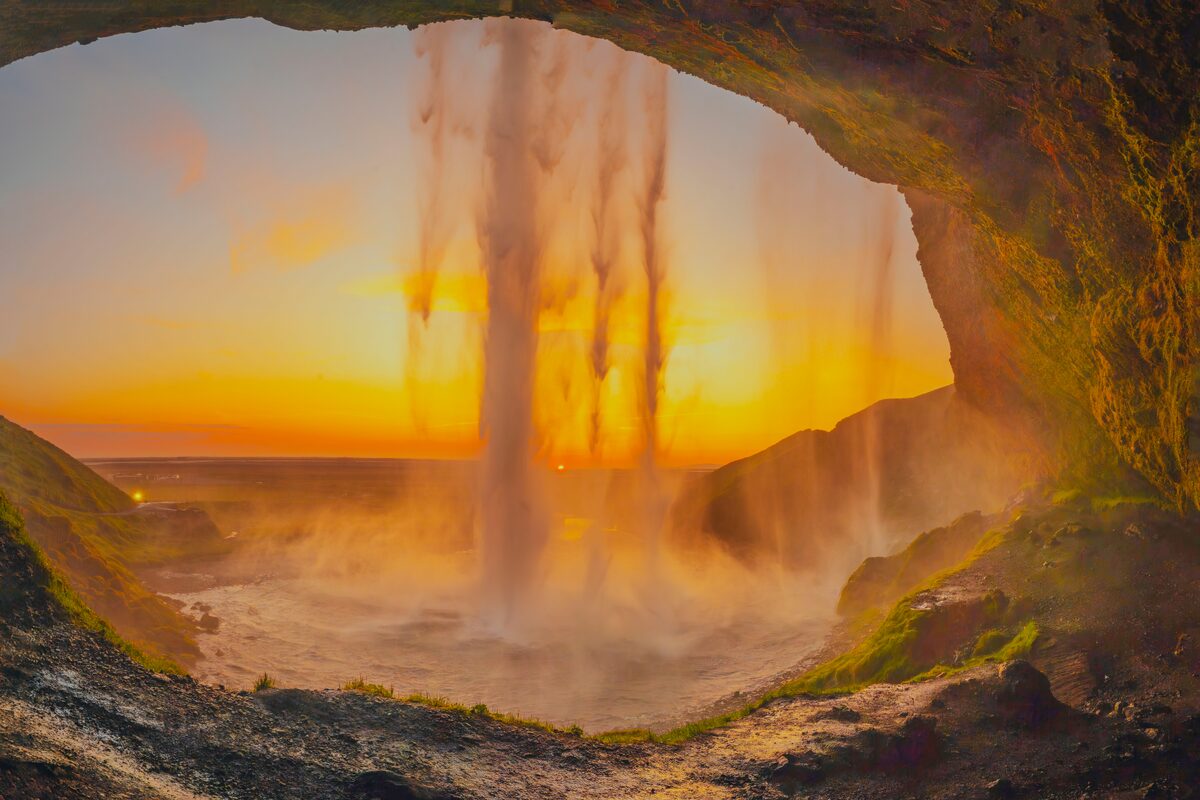 South coast Seljalandsfoss waterfall during birhgt orange sunset in summer time.