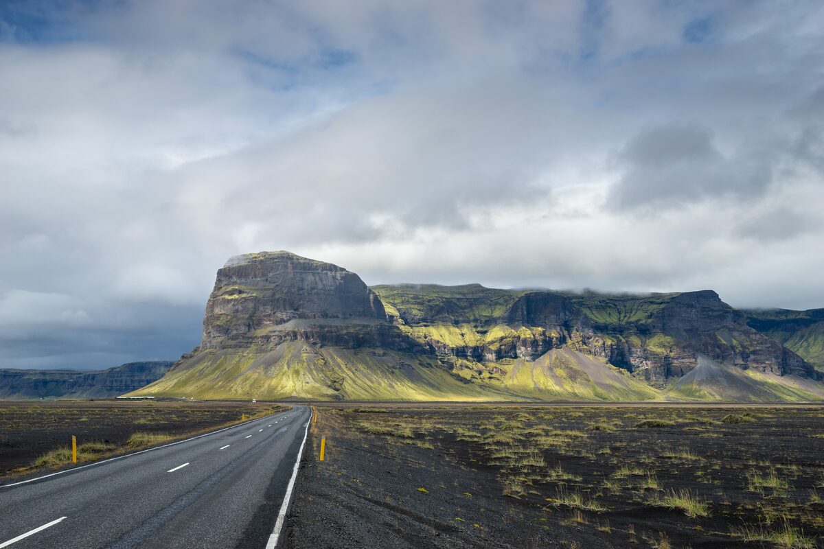 Road leading to Lomagnupur mountain on the south coast of Iceland on cloudy day.