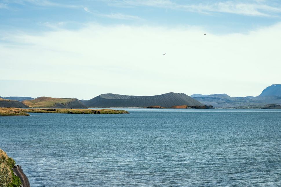Large lake Myvatn in summer and view of large crater in distance.