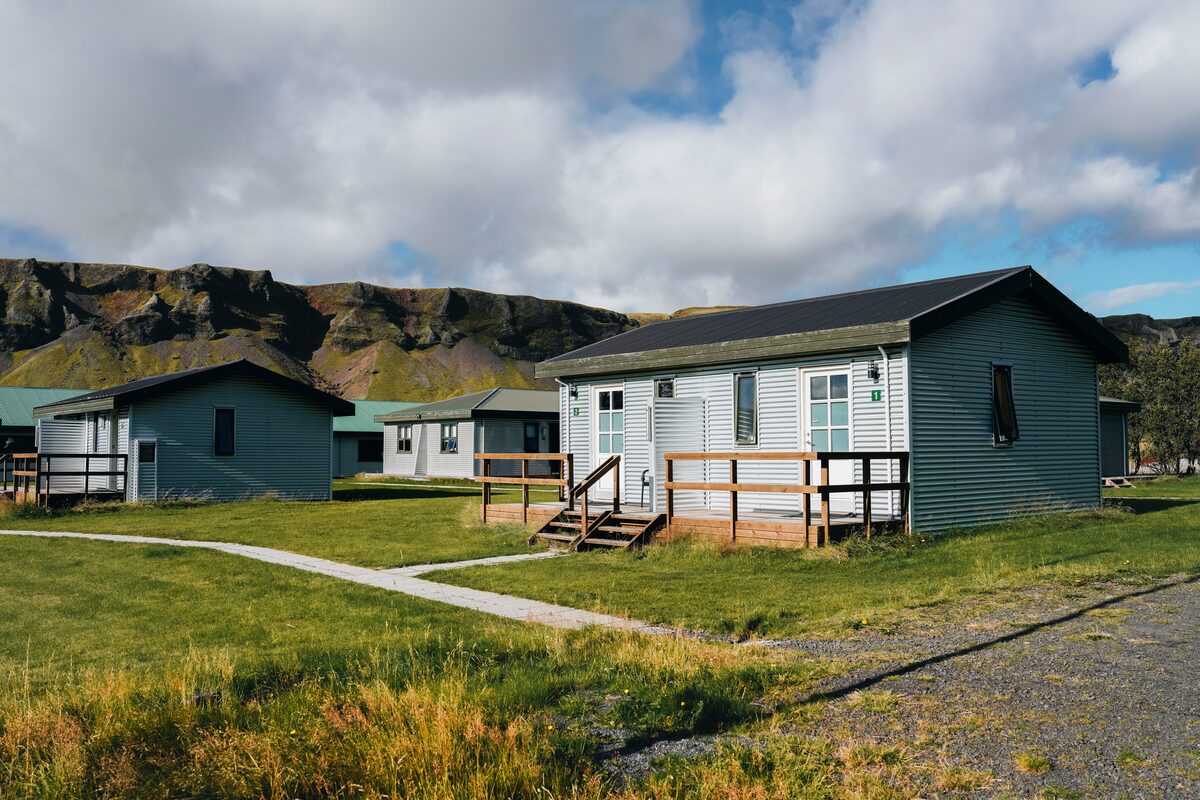 Adventure hotel Geirland with rugged moss covered cliffs behind hotel cabin.